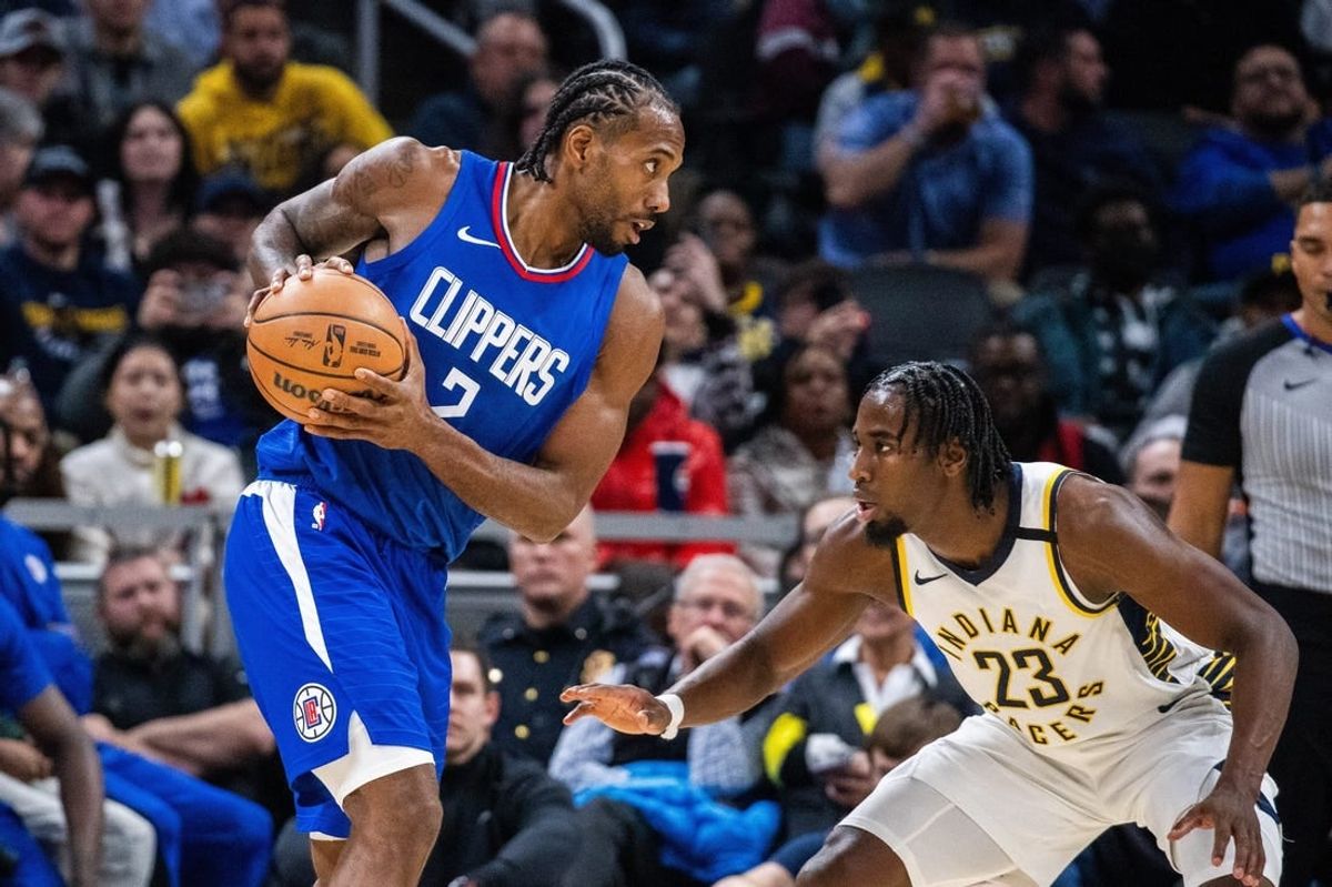 Dec 18, 2023; Indianapolis, Indiana, USA;  LA Clippers forward Kawhi Leonard (2) holds the ball while Indiana Pacers forward Aaron Nesmith (23) defends in the second half at Gainbridge Fieldhouse.
