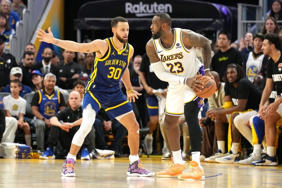 Jan 27, 2024; San Francisco, California, USA; Golden State Warriors guard Stephen Curry (30) defends against Los Angeles Lakers forward LeBron James (23) during overtime at Chase Center.