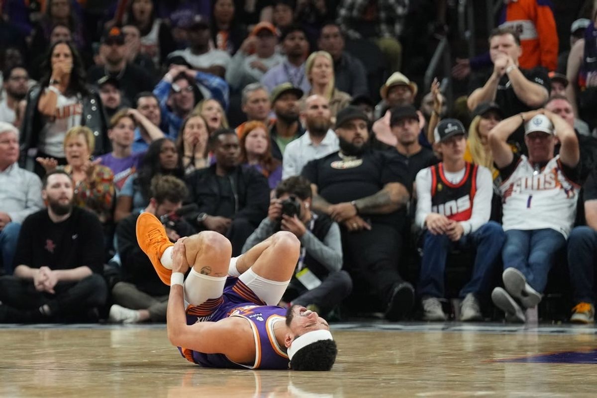 Mar 2, 2024; Phoenix, Arizona, USA; Phoenix Suns guard Devin Booker (1) reacts after being inured against the Houston Rockets during the second half at Footprint Center.