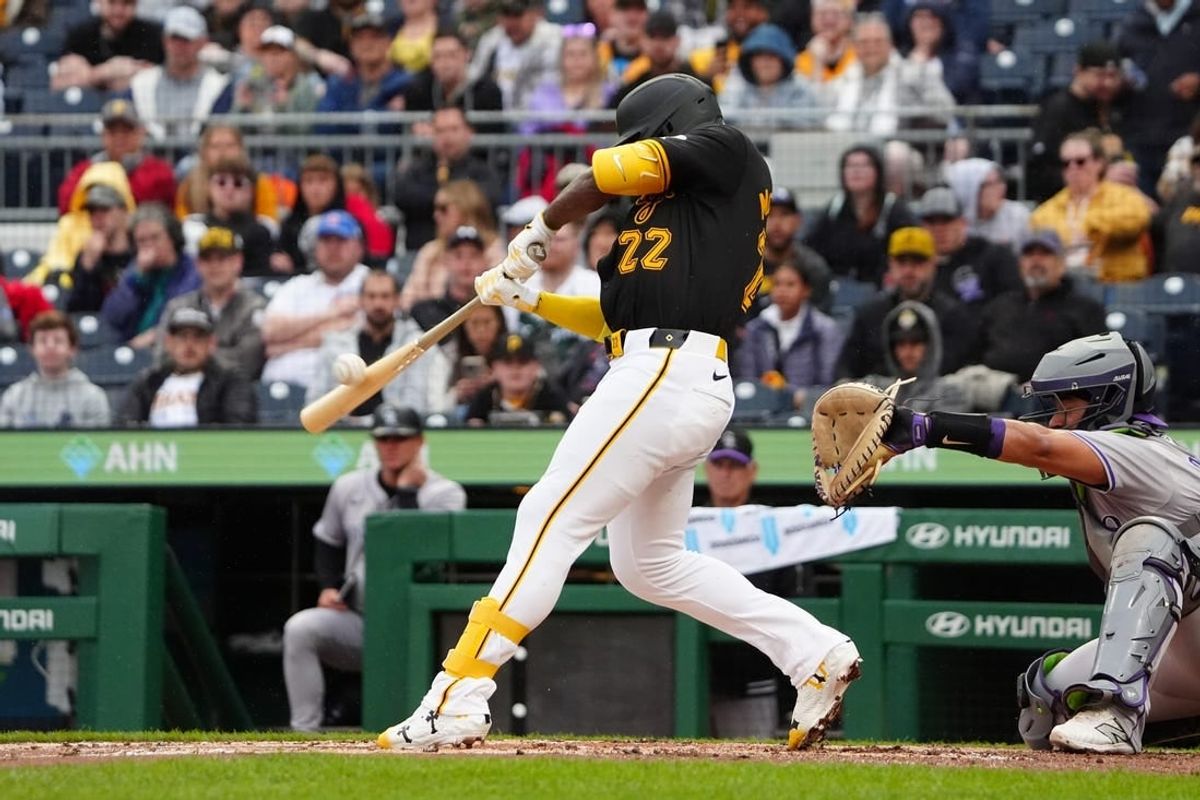 May 4, 2024; Pittsburgh, Pennsylvania, USA; Pittsburgh Pirates designated hitter Andrew McCutchen (22) hits a single against the Colorado Rockies during the third inning at PNC Park.