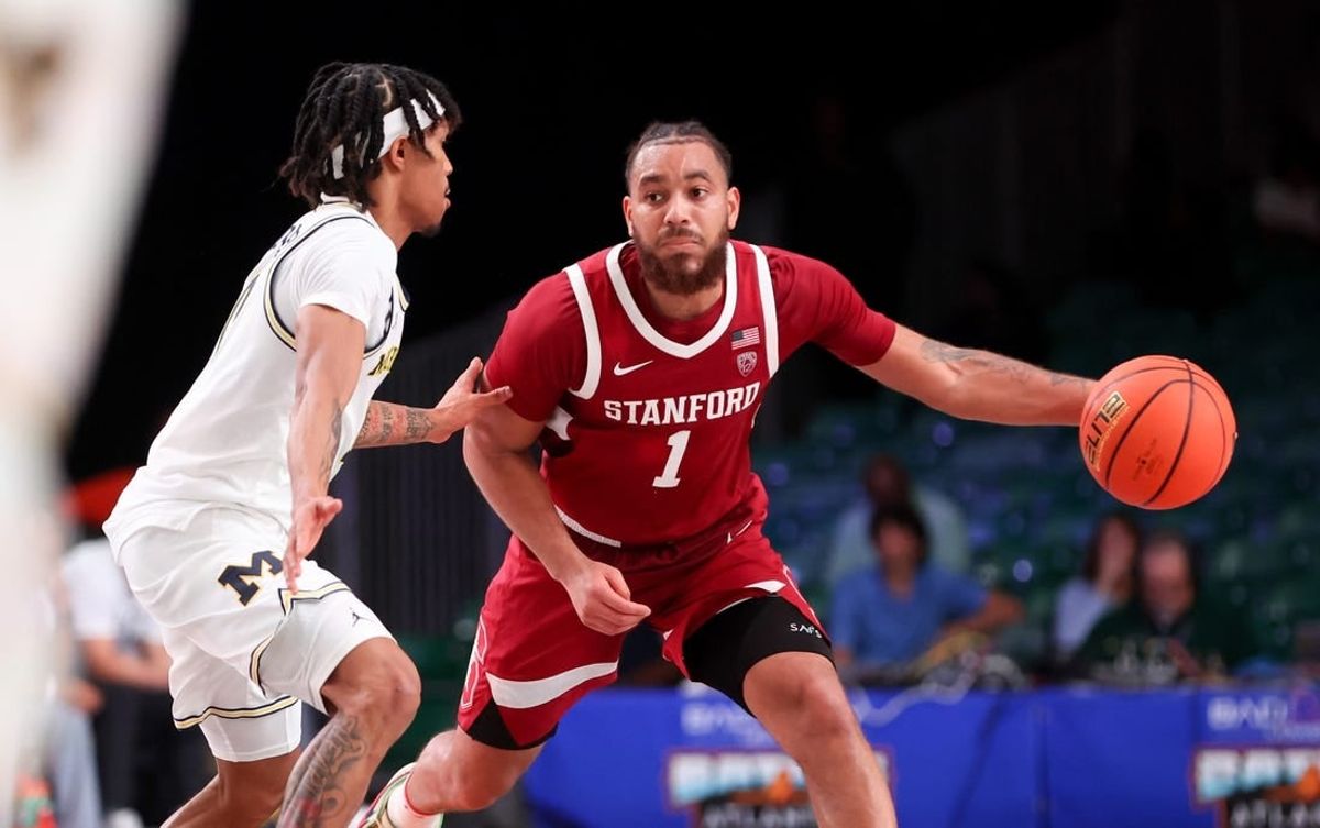 Nov 23, 2023; Paradise Island, BAHAMAS;  Stanford Cardinal guard Jared Bynum (1) drives to the basket as Michigan Wolverines guard Dug McDaniel (0) defends during the second half at Imperial Arena.