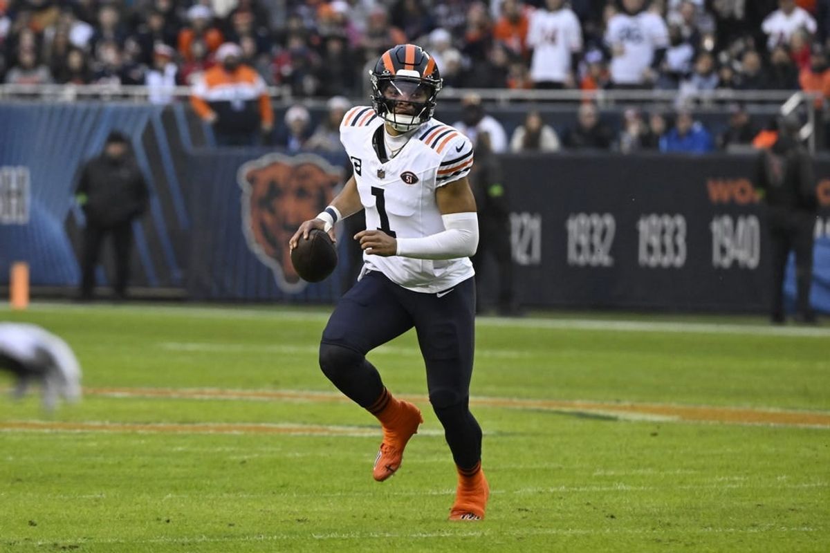 Dec 24, 2023; Chicago, Illinois, USA;  Chicago Bears quarterback Justin Fields (1) looks to pass the ball against the Arizona Cardinals during the first half at Soldier Field.