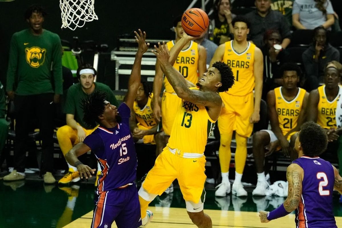 Dec 2, 2023; Waco, Texas, USA; Baylor Bears guard Langston Love (13) shoots against Northwestern State Demons guard Chase Forte (15) during the second half at Ferrell Center.