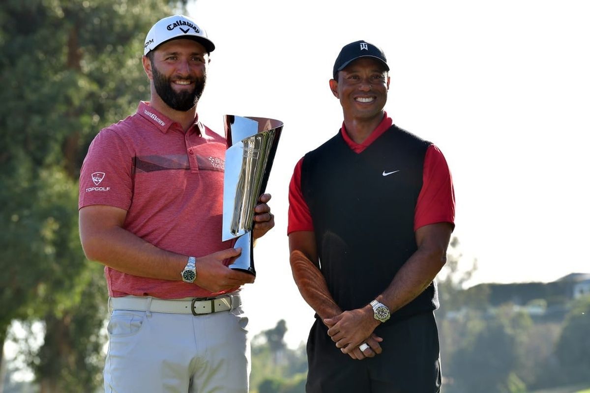 Feb 19, 2023; Pacific Palisades, California, USA; Jon Rahm poses for photos with Tiger Woods following his victory in the final round of The Genesis Invitational golf tournament.