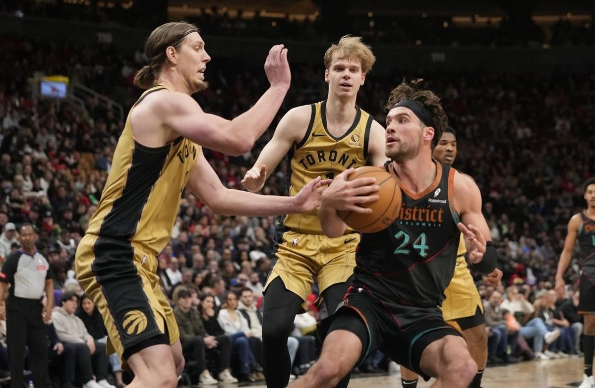 Apr 7, 2024; Toronto, Ontario, CAN; Toronto Raptors forward Kelly Olynyk (41) and guard Gradey Dick (1) defend against Washington Wizards forward Corey Kispert (24)  during the first half at Scotiabank Arena.