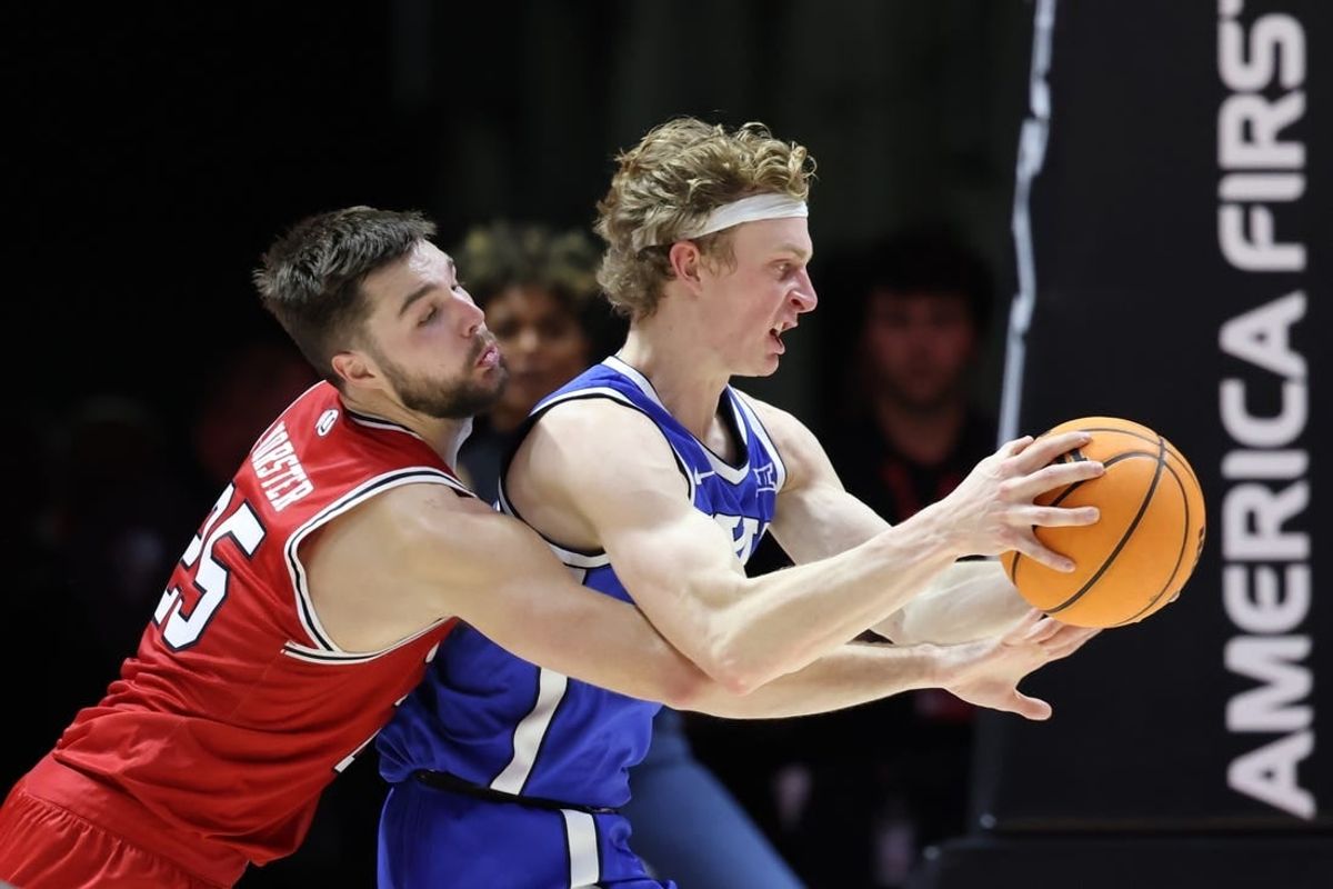 Dec 9, 2023; Salt Lake City, Utah, USA; Utah Utes guard Rollie Worster (25) and Brigham Young Cougars guard Richie Saunders (15) battle for the ball during the second half at Jon M. Huntsman Center.