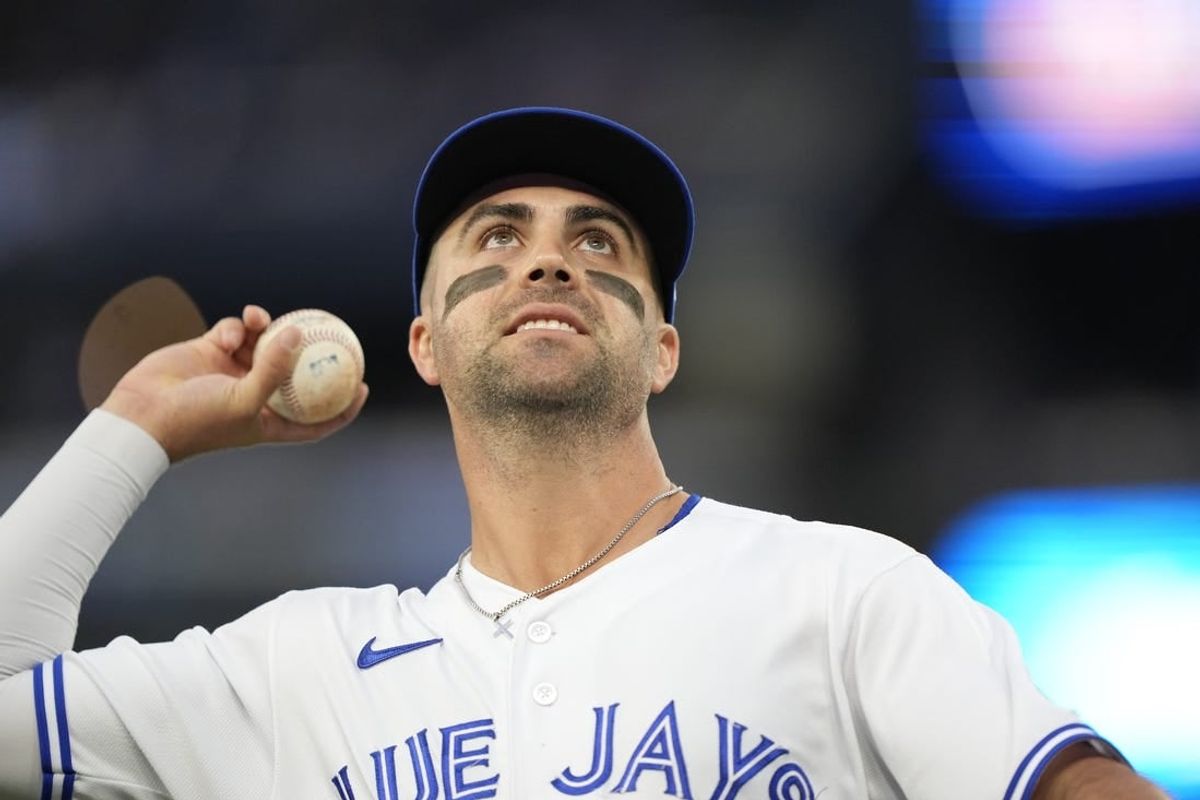 Sep 8, 2023; Toronto, Ontario, CAN; Toronto Blue Jays second baseman Whit Merrifield (15) goes to throw a ball to a fan during the second inning against the Kansas City Royals at Rogers Centre.