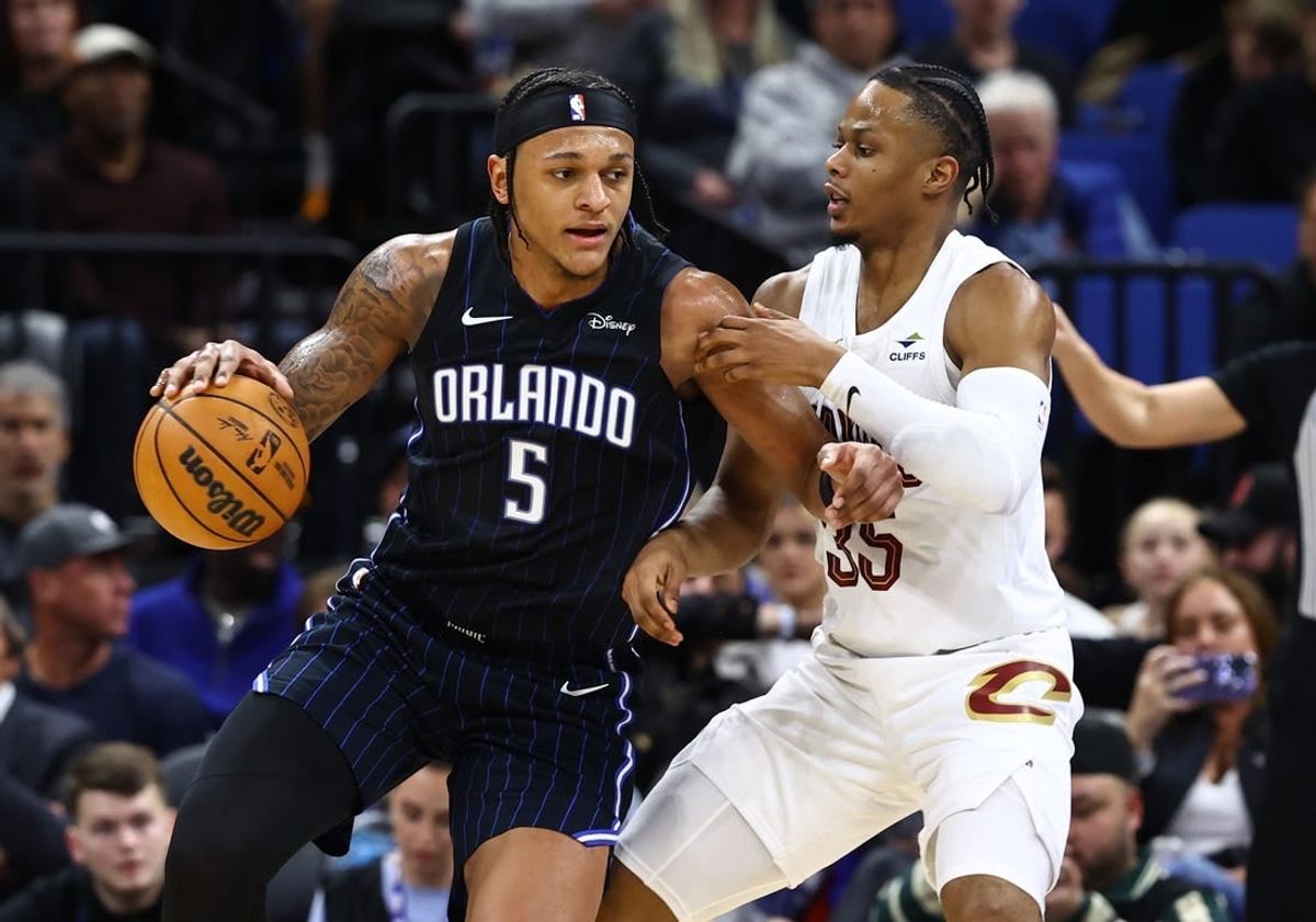 Jan 22, 2024; Orlando, Florida, USA; Cleveland Cavaliers forward Isaac Okoro (35) defends Orlando Magic forward Paolo Banchero (5) during the second quarter at Kia Center.