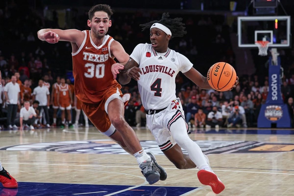 Nov 19, 2023; New York, New York, USA; Louisville Cardinals guard Ty-Laur Johnson (4) drives to the basket against Texas Longhorns forward Brock Cunningham (30) during the second half at Madison Square Garden.