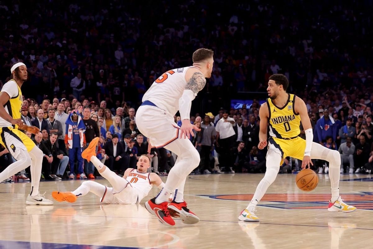 May 6, 2024; New York, New York, USA; New York Knicks guard Donte DiVincenzo (0) is fouled on a moving pick by Indiana Pacers center Myles Turner (33) as Pacers guard Tyrese Haliburton (0) dribbles against Knicks center Isaiah Hartenstein (55) during the fourth quarter of game one of the second round of the 2024 NBA playoffs at Madison Square Garden.