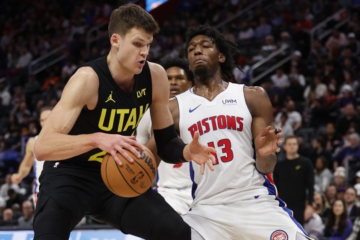 Dec 21, 2023; Detroit, Michigan, USA;  Utah Jazz center Walker Kessler (24) is defended by Detroit Pistons center James Wiseman (13) in the second half at Little Caesars Arena.