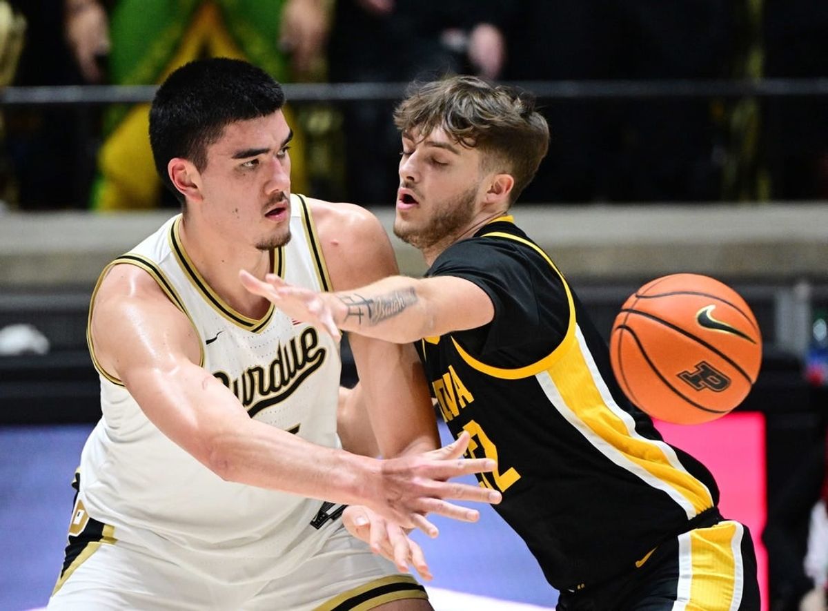 Dec 4, 2023; West Lafayette, Indiana, USA; Purdue Boilermakers center Zach Edey (15) passes the ball past Iowa Hawkeyes forward Owen Freeman (32) during the first half at Mackey Arena.