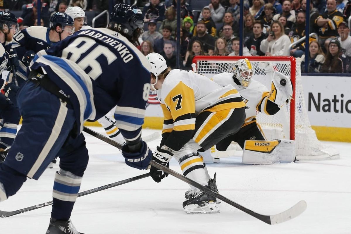 Mar 30, 2024; Columbus, Ohio, USA; Pittsburgh Penguins goalie Alex Nedeljkovic (39) makes a glove save on the shot attempt of Columbus Blue Jackets right wing Kirill Marchenko (86) during the first period at Nationwide Arena.