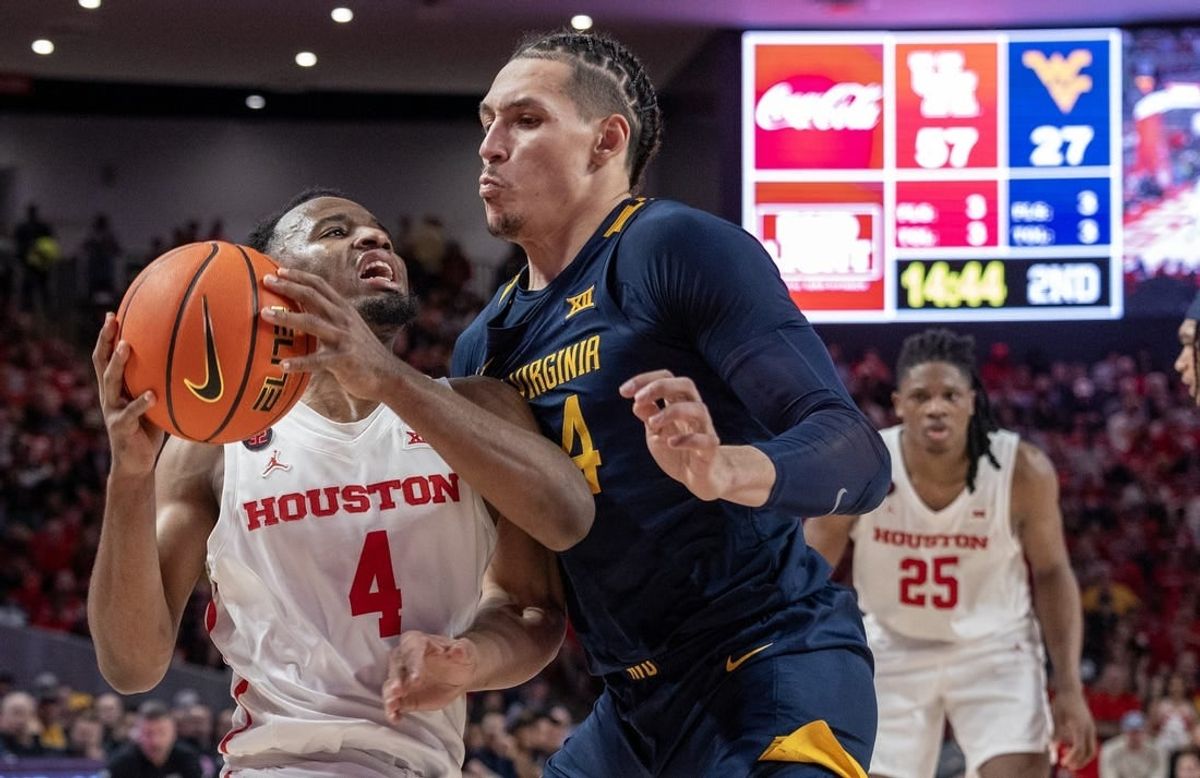Jan 6, 2024; Houston, Texas, USA; Houston Cougars guard L.J. Cryer (4) drives against West Virginia Mountaineers forward Patrick Suemnick (24) in the second half at Fertitta Center.