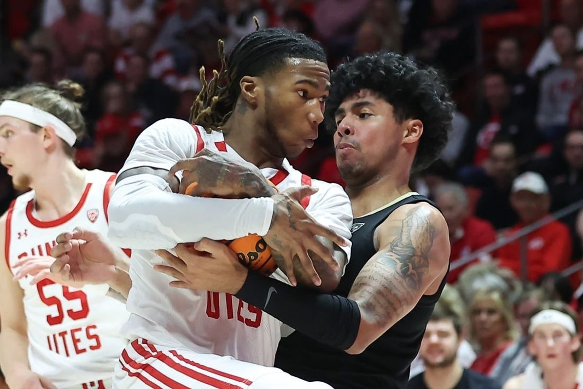 Feb 3, 2024; Salt Lake City, Utah, USA; Utah Utes guard Deivon Smith (5) and Colorado Buffaloes guard Julian Hammond III (3) battle for the ball during the first half at Jon M. Huntsman Center.