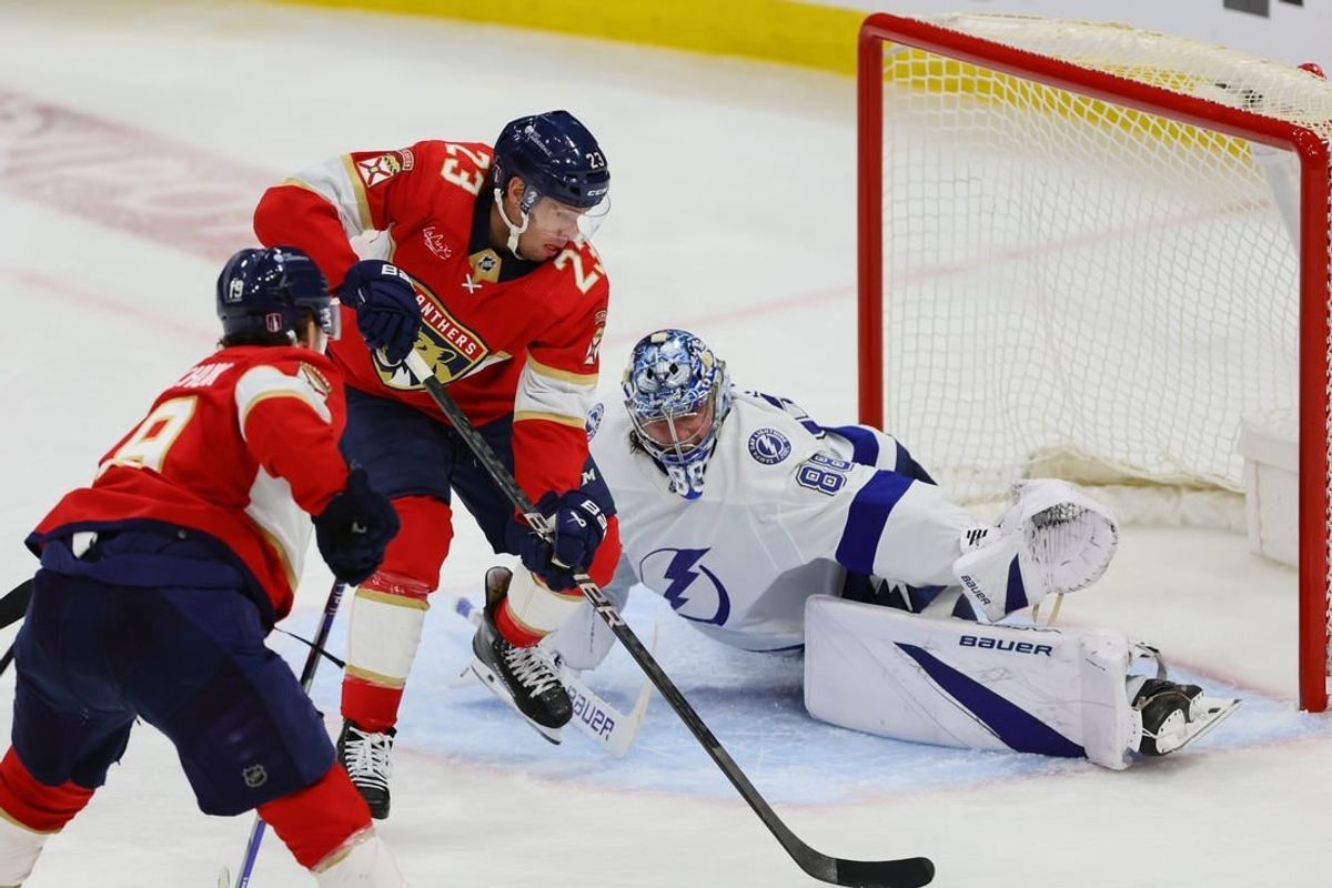 Apr 23, 2024; Sunrise, Florida, USA; Florida Panthers center Carter Verhaeghe (23) shoots the puck and scores against Tampa Bay Lightning goaltender Andrei Vasilevskiy (88) during overtime in game two of the first round of the 2024 Stanley Cup Playoffs at Amerant Bank Arena.