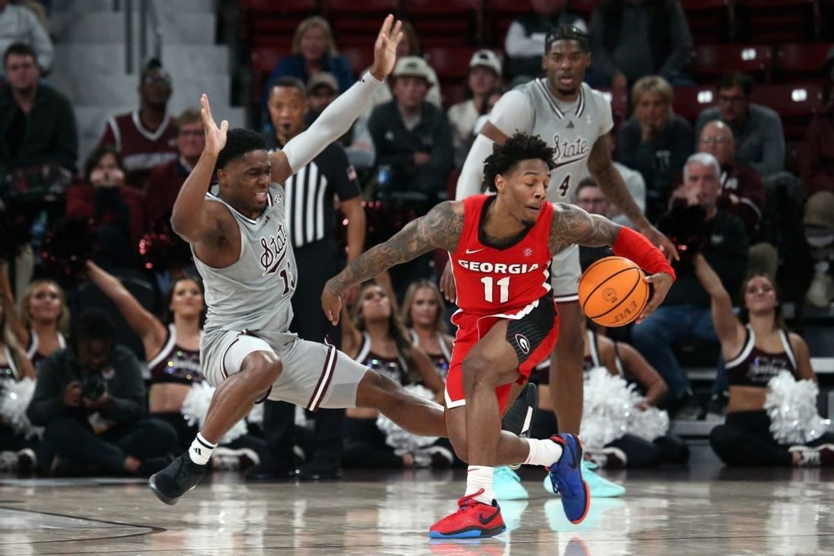 Feb 7, 2024; Starkville, Mississippi, USA; Georgia Bulldogs guard Justin Hill (11) dribbles as Mississippi State Bulldogs guard Josh Hubbard (13) defends during the second half at Humphrey Coliseum.