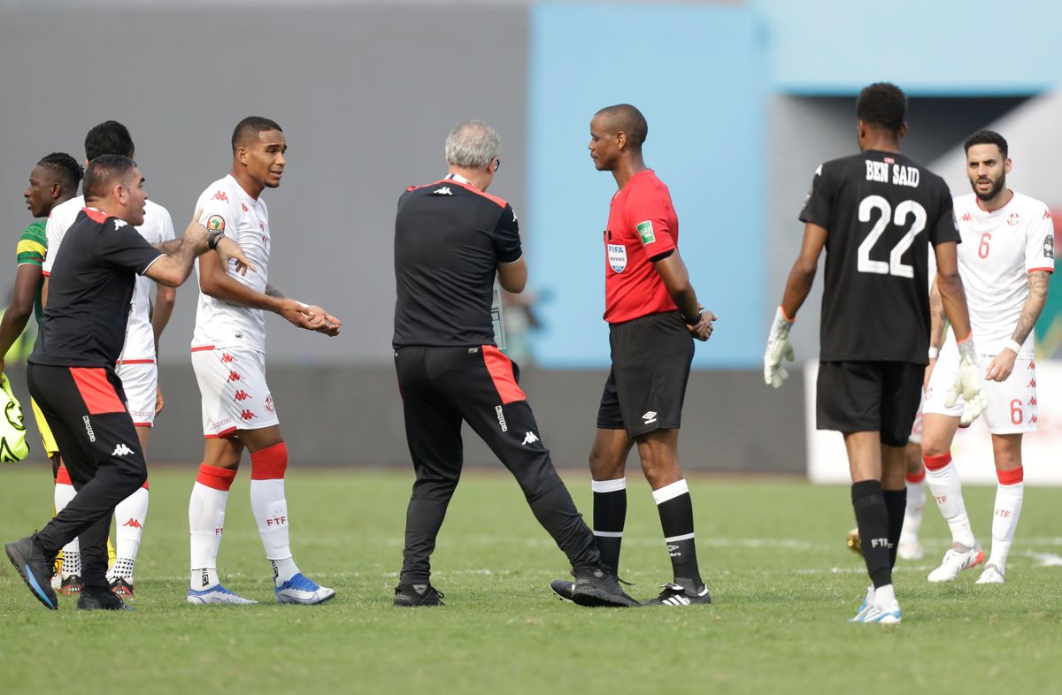 Tunisia’s head coach Mondher Kebaier, center left, cannot believe referee Janny Sikazwe blew the whistle early in his team’s match against Mali.