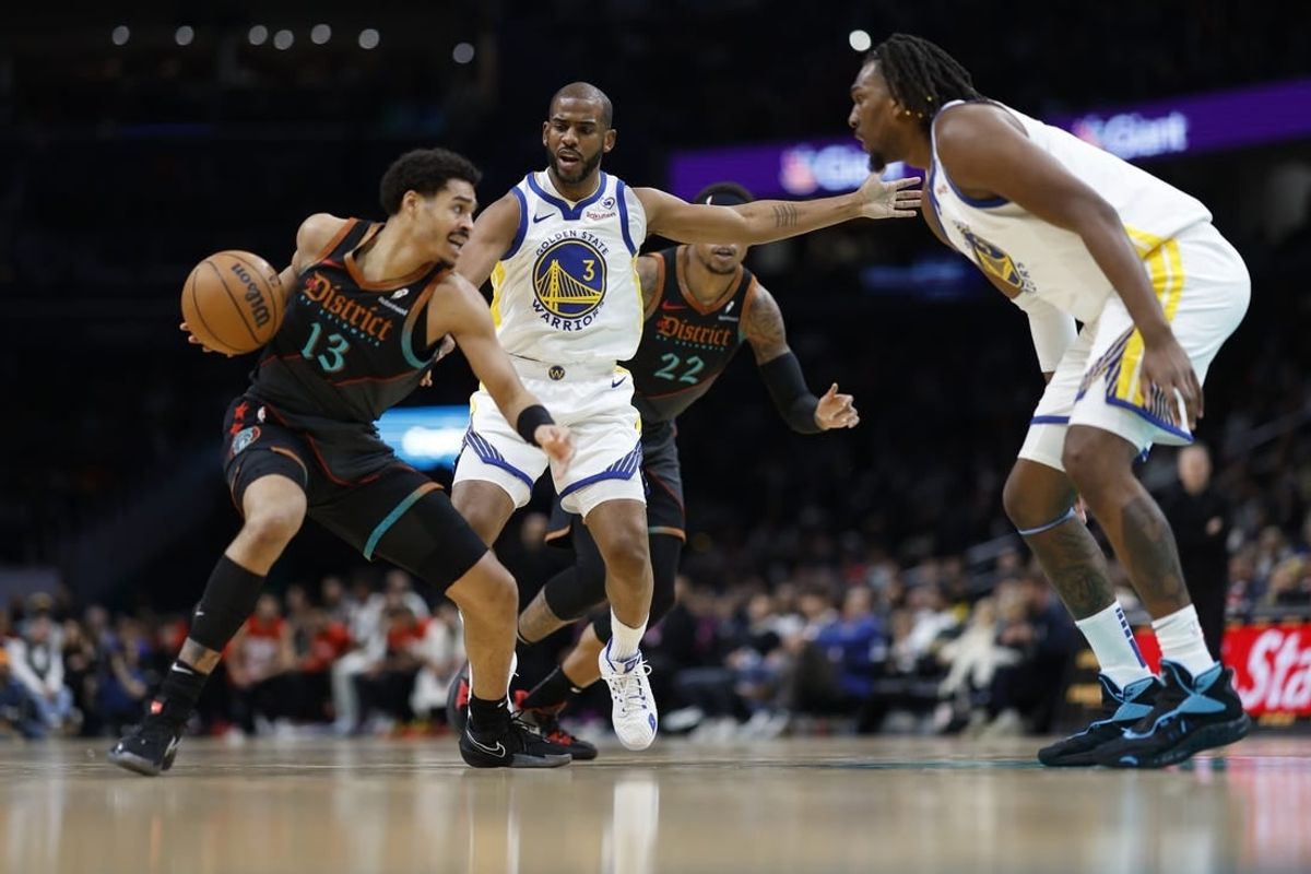 Feb 27, 2024; Washington, District of Columbia, USA; Washington Wizards guard Jordan Poole (13) drives to the basket as Golden State Warriors guard Chris Paul (3) defends in the first half at Capital One Arena.
