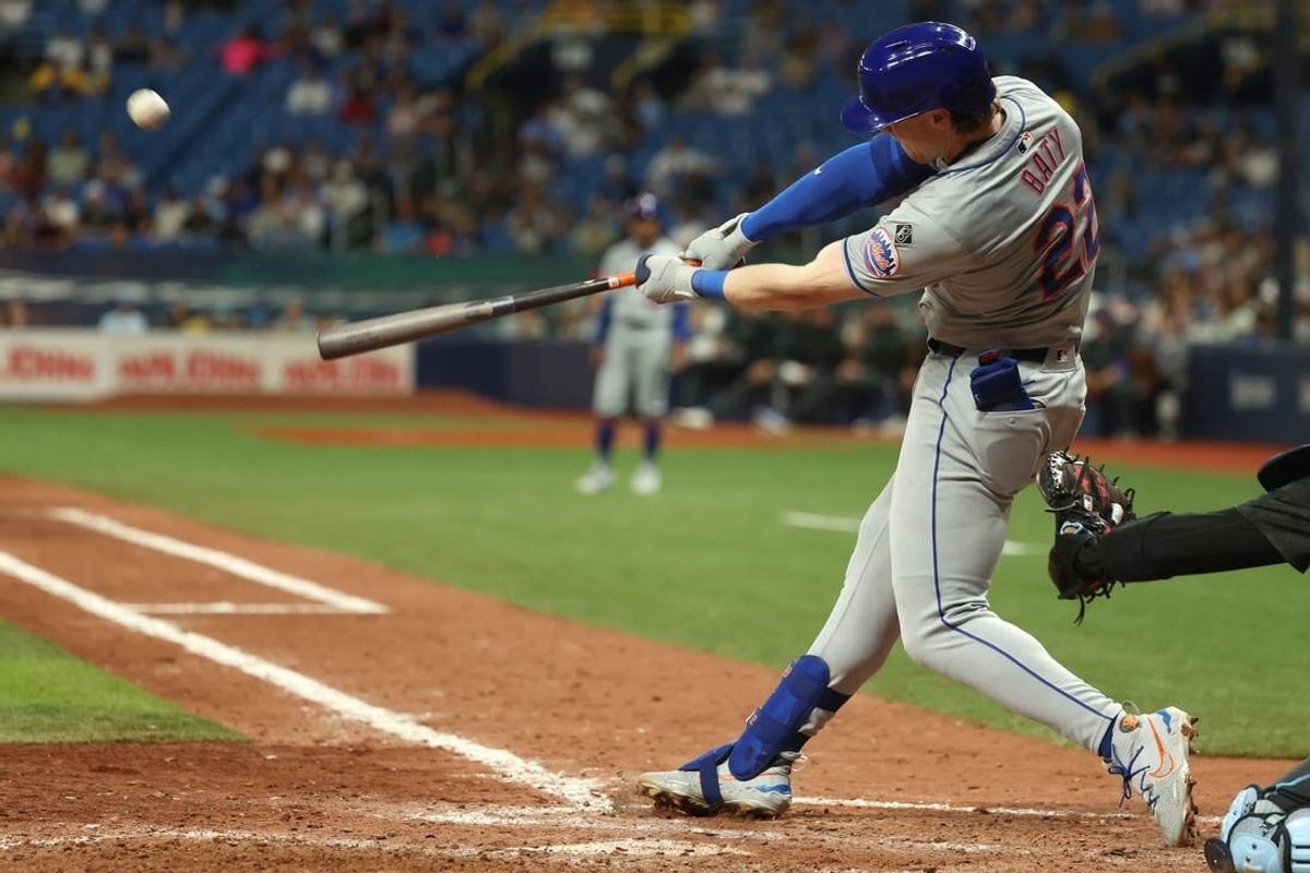 May 3, 2024; St. Petersburg, Florida, USA;  New York Mets third base Brett Baty (22) hits a home run against the Tampa Bay Rays during the ninth inning at Tropicana Field.