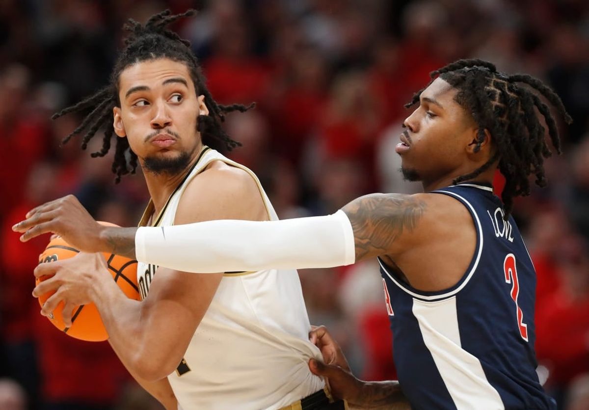 Purdue Boilermakers forward Trey Kaufman-Renn (4) is defended by Arizona Wildcats guard Caleb Love (2) during the NCAA men   s basketball game, Saturday, Dec. 16, 2023, at Gainbridge Fieldhouse in Indianapolis. Purdue Boilermakers won 92-84.