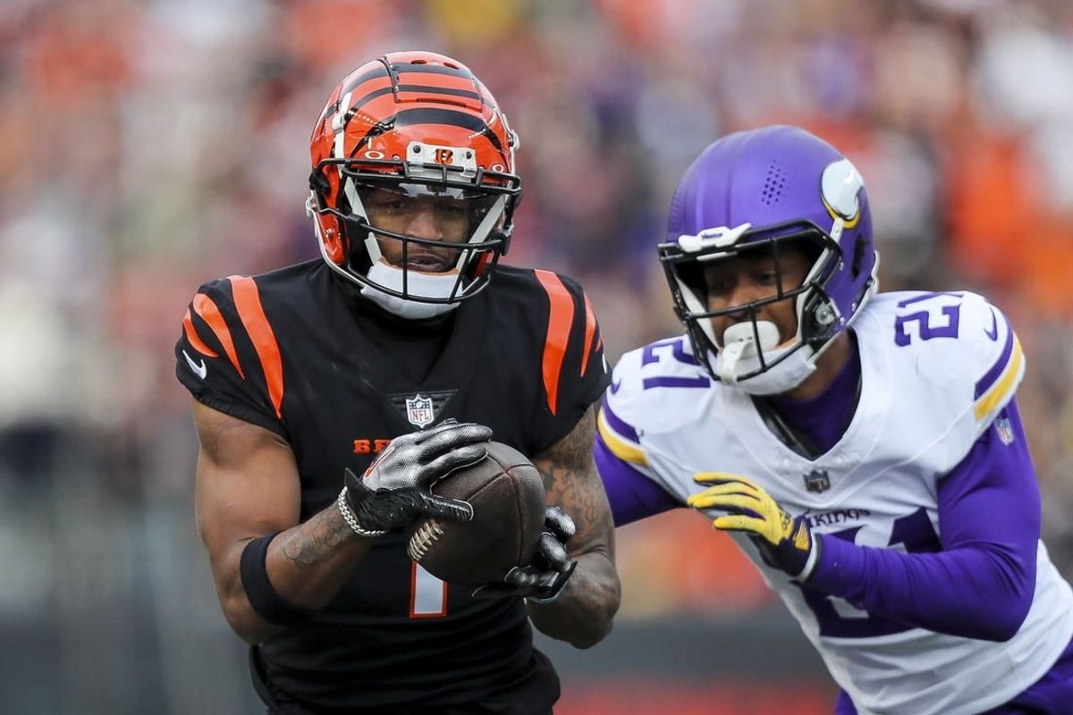 Dec 16, 2023; Cincinnati, Ohio, USA; Cincinnati Bengals wide receiver Ja'Marr Chase (1) runs with the ball against Minnesota Vikings cornerback Akayleb Evans (21) in the first half at Paycor Stadium.