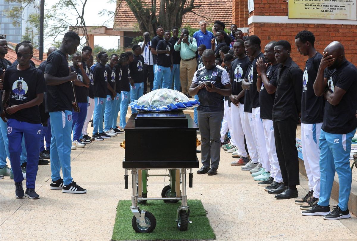 Ugandan soccer players pay homage around the coffin before attending the requiem mass of the late David Owori, 28, Uganda international soccer player and captain of SC Villa, who was critically injured by unidentified assailants and was later pronounced dead, at the St. Peter's Catholic Church Nsambya in Kampala, Uganda August 6, 2026.