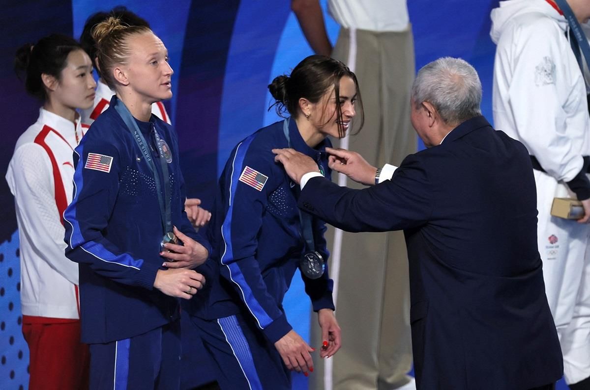 Silver medalist Kassidy Cook of United States receives her medal next to silver medalist Sarah Bacon of United States.