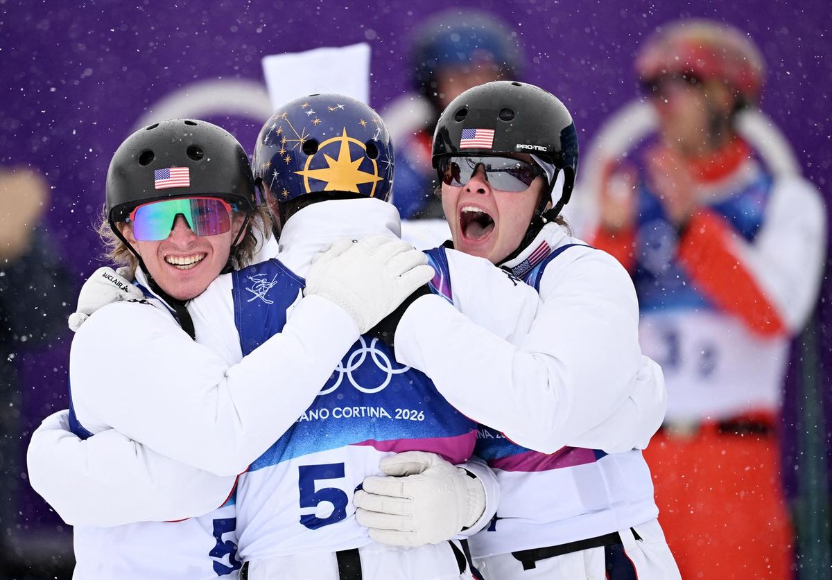 Gold medalists Christopher Lillis, Kaila Kuhn and Connor Curran of the United States celebrate after winning the mixed team aerials final at the Milan Cortina Olympics on Saturday in Livigno, Italy.