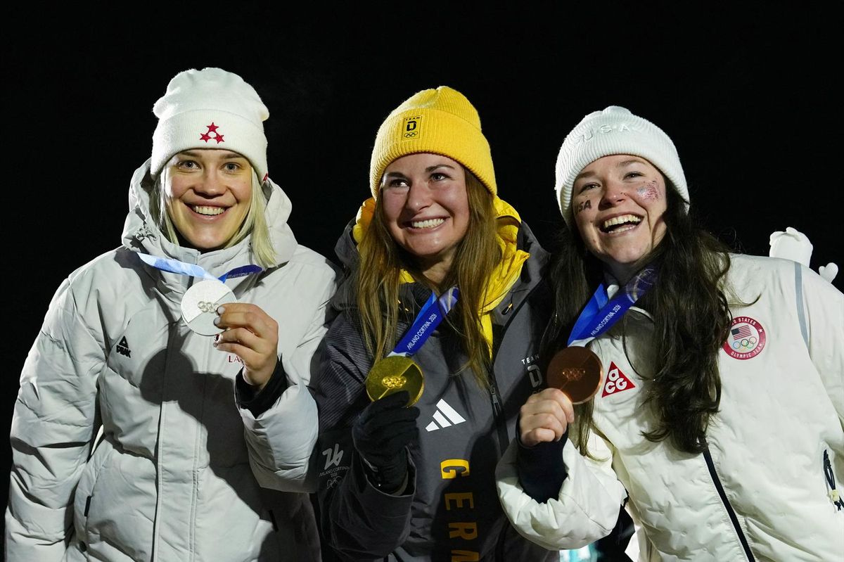 Milano Cortina 2026 Olympics - Luge - Women's Singles Victory Ceremony - Cortina Sliding Centre, Cortina d'Ampezzo, Italy - February 10, 2026. Gold medallist Julia Taubitz of Germany celebrates during the women's singles victory ceremony with silver medallist Elina Bota of Latvia and bronze medallist Ashley Farquharson of United States.
