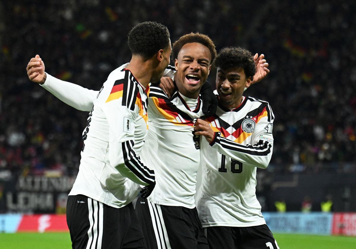 Germany's Assan Ouedraogo celebrates scoring their sixth goal with Felix Nmecha and Nathaniel Brown against Slovakia at Red Bull Arena in Leipzig on Nov. 17, 2025.