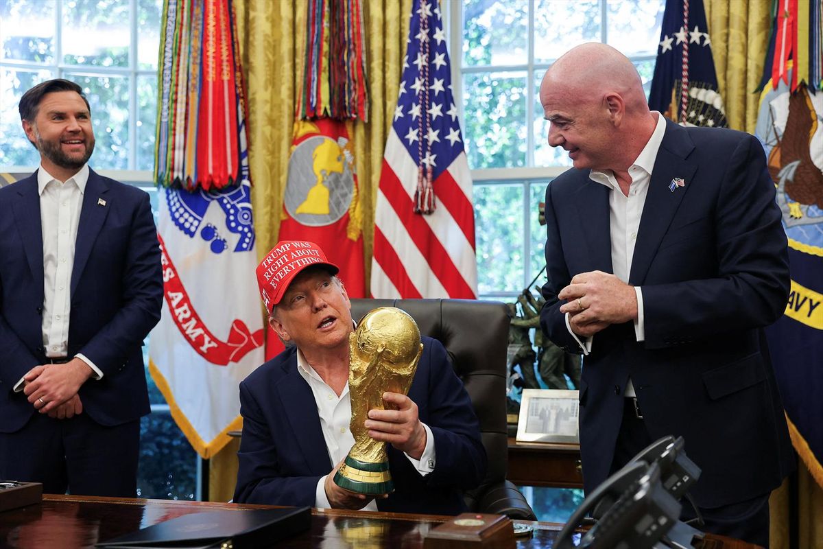 U.S. President Donald Trump holds the FIFA World Cup Trophy as Vice President JD Vance and FIFA president Gianni Infantino stand in the Oval Office at the White House in Washington, D.C., on Aug. 22, 2025.