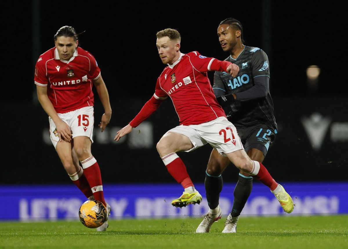 Wrexham's George Dobson and Lewis O'Brien in action against Ipswich Town's Jens Cajuste on Feb. 13, 2026.