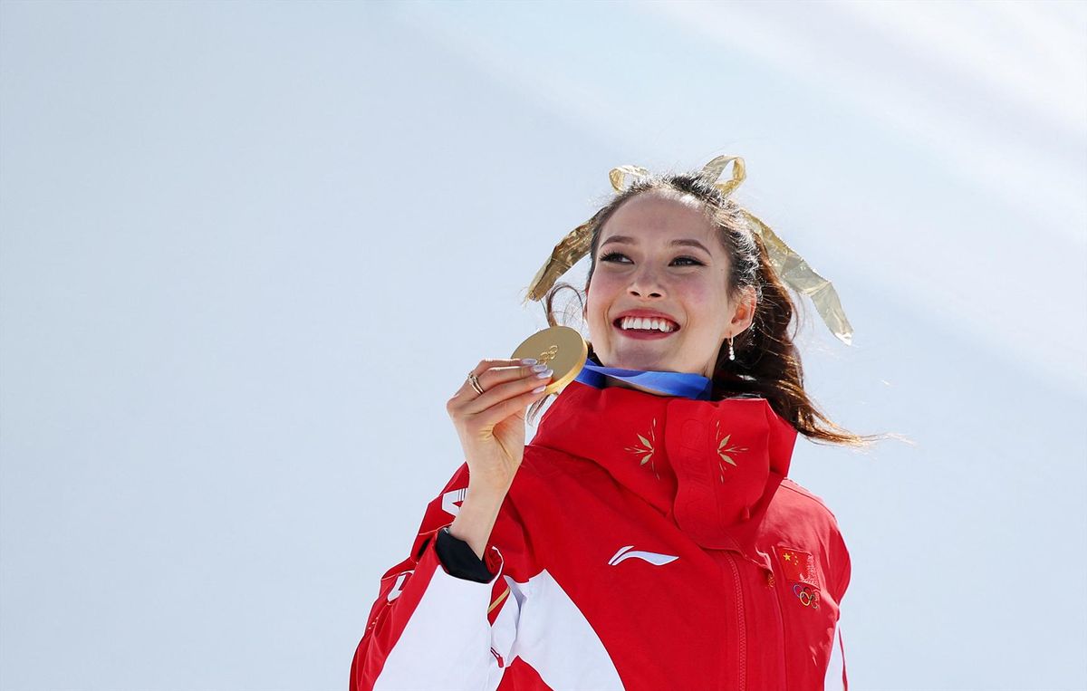 Gold medallist Eileen Gu of China celebrates on the podium during the women's freeski halfpipe victory ceremony at the Milan Cortina Olympics on Sunday.