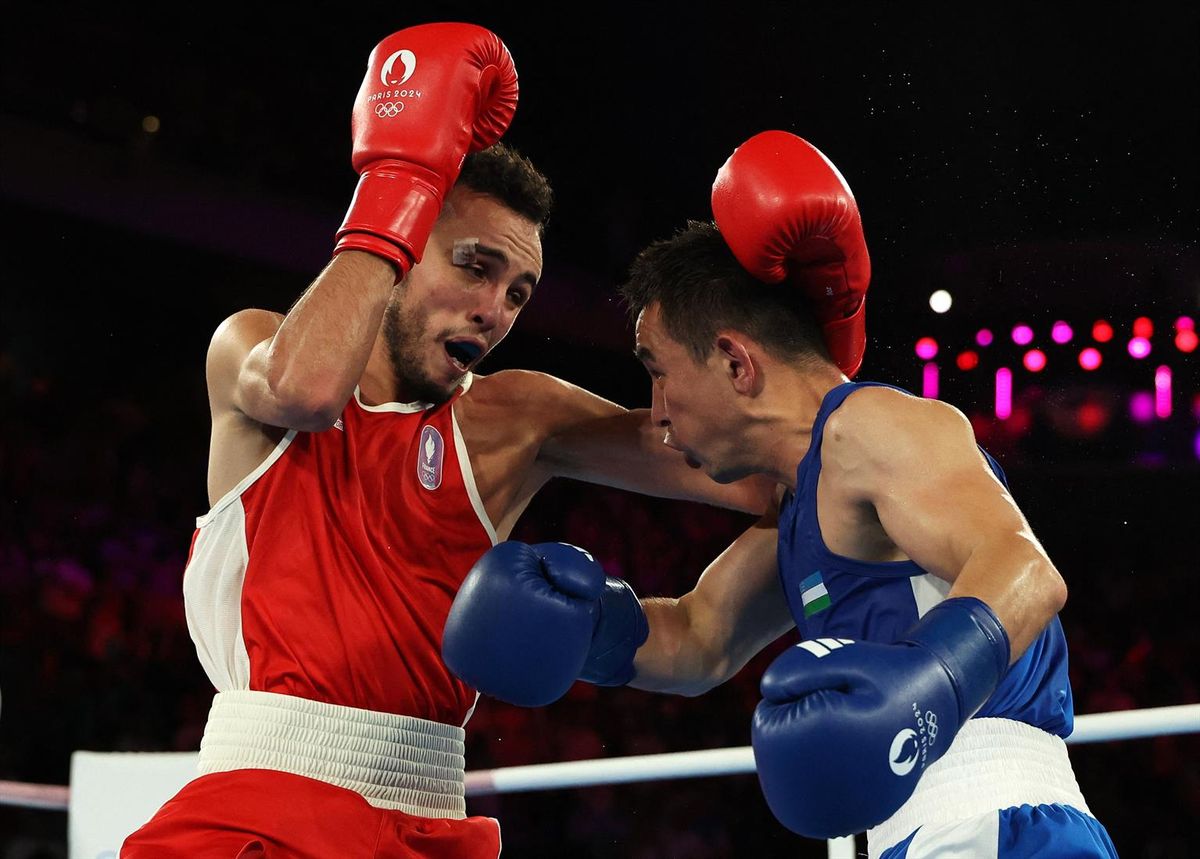 Paris 2024 Olympics - Boxing - Men's 51kg - Final - Roland-Garros Stadium, Paris, France - August 08, 2024. Hasanboy Dusmatov of Uzbekistan in action against Billal Bennama of France. REUTERS/Maye-E Wong