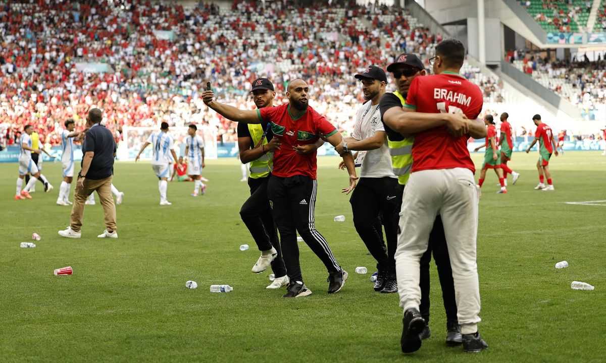 Pitch invaders are detained by stewards after the match between Argentina and Morocco at Geoffroy-Guichard Stadium, Saint-Etienne, France - July 24, 2024. (REUTERS/Thaier Al-Sudani)