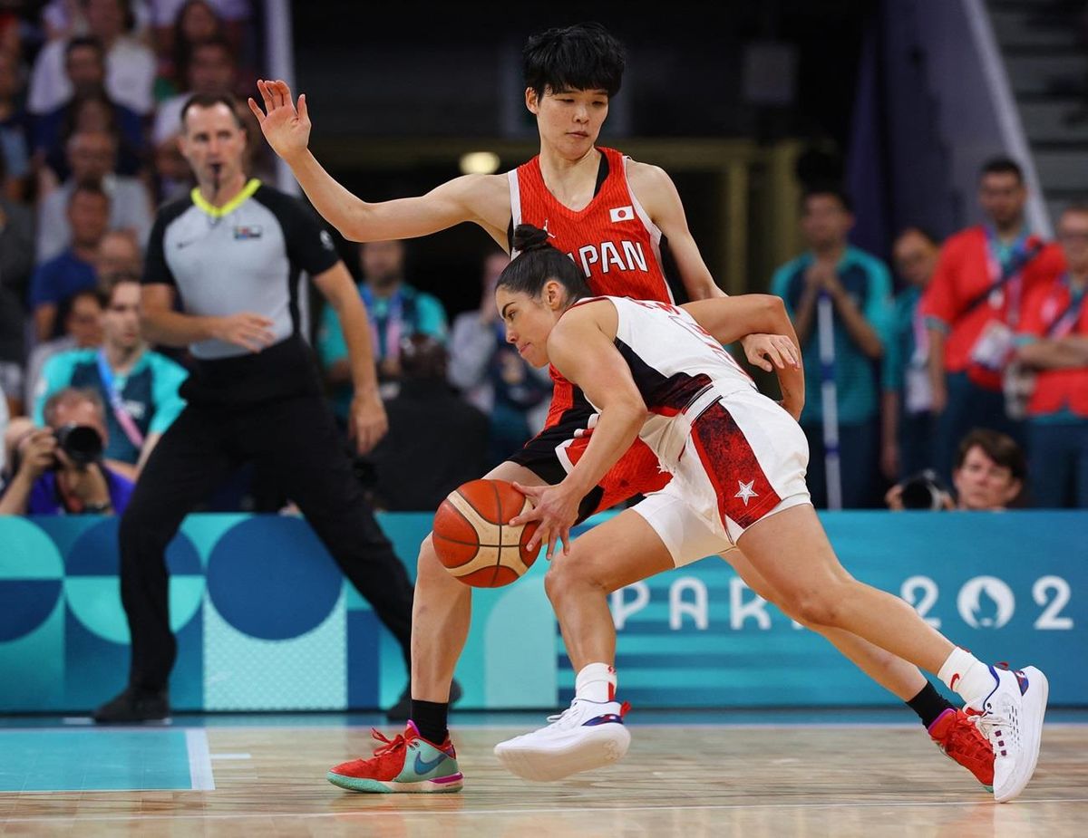 Kelsey Plum of United States in action against Himawari Akaho of Japan in the first game of Olympic pool play in the 2024 Paris Games.