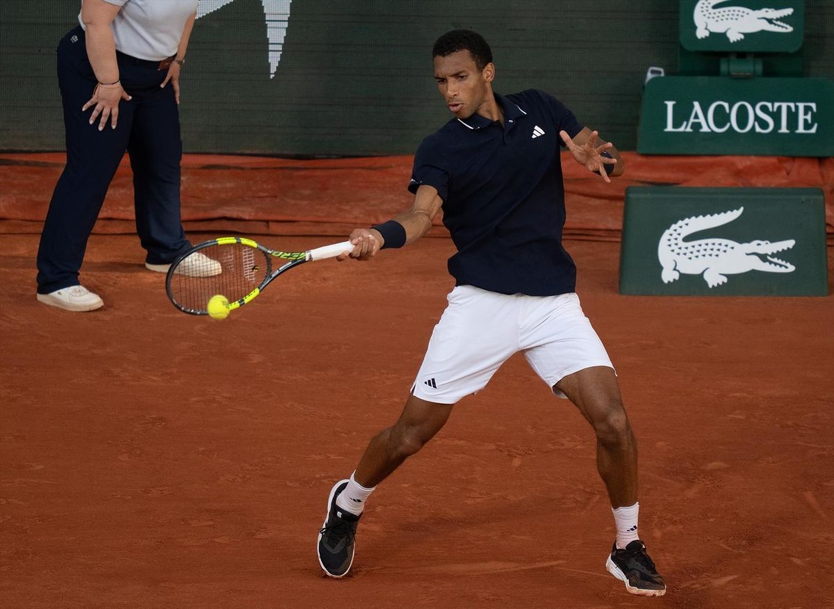Jun 1, 2026; Paris, France; Felix Auger-Aliassime of Canada returns a shot during his match against Alejandro Tabico of Chile on day nine at Stade Roland Garros.