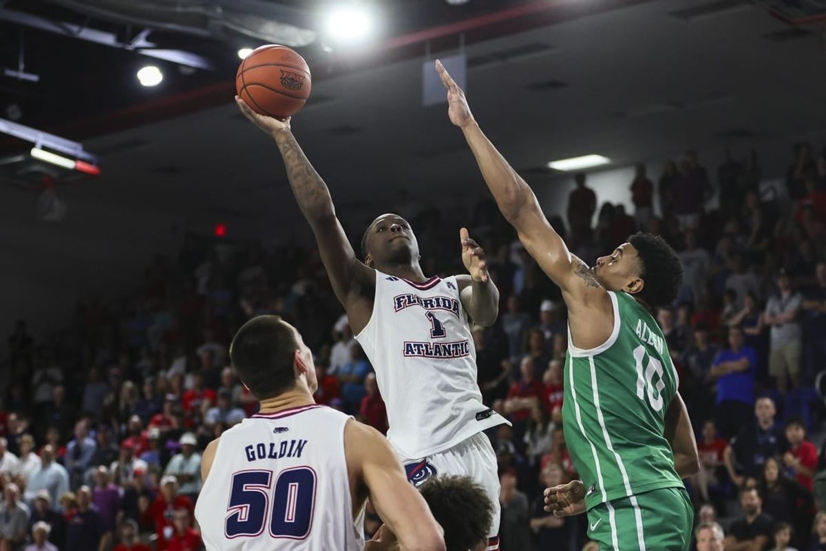 Jan 28, 2024; Boca Raton, Florida, USA; Florida Atlantic Owls guard Johnell Davis (1) shoots the basketball over North Texas Mean Green forward Robert Allen (10) during the second half at Eleanor R. Baldwin Arena.