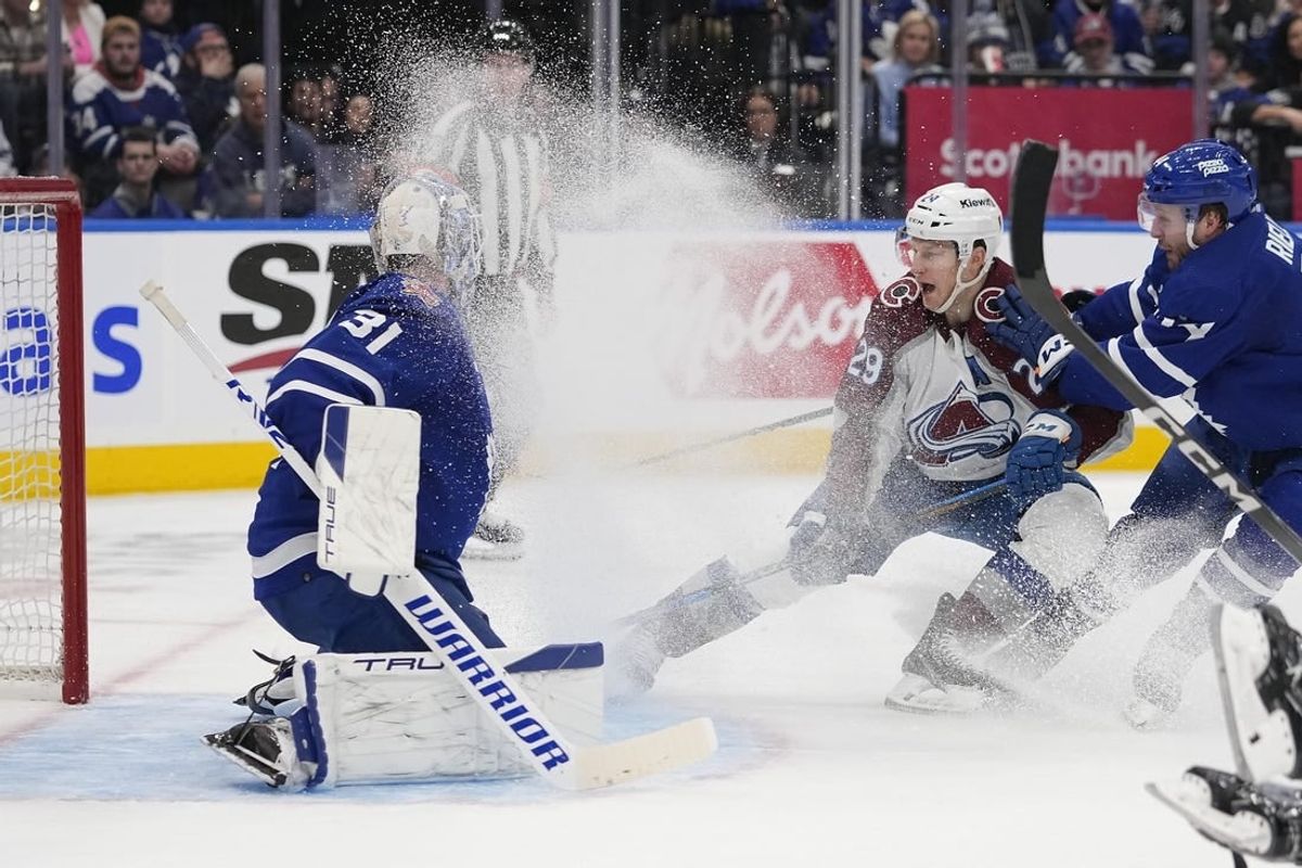 Jan 13, 2024; Toronto, Ontario, CAN; Colorado Avalanche forward Nathan MacKinnon (29) tries to knock in a puck on Toronto Maple Leafs goaltender Martin Jones (31) as Toronto Maple Leafs defenseman Morgan Rielly (44) defends during the second period at Scotiabank Arena.