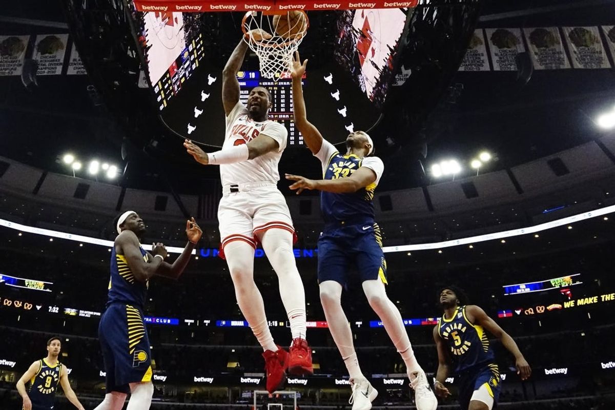 Mar 27, 2024; Chicago, Illinois, USA; Chicago Bulls center Andre Drummond (3) dunks on Indiana Pacers center Myles Turner (33) during the first quarter at United Center.