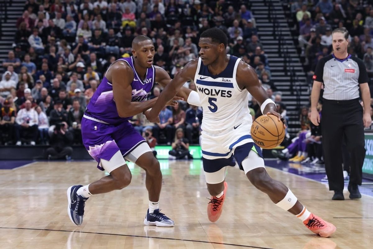 Mar 18, 2024; Salt Lake City, Utah, USA; Minnesota Timberwolves guard Anthony Edwards (5) drives against Utah Jazz guard Kris Dunn (11) during the third quarter at Delta Center.