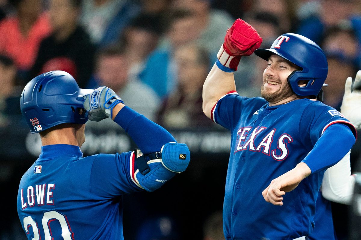 Nathaniel Lowe (l.) celebrates his three-run home run against the Toronto Blue Jays with Robbie Grossman