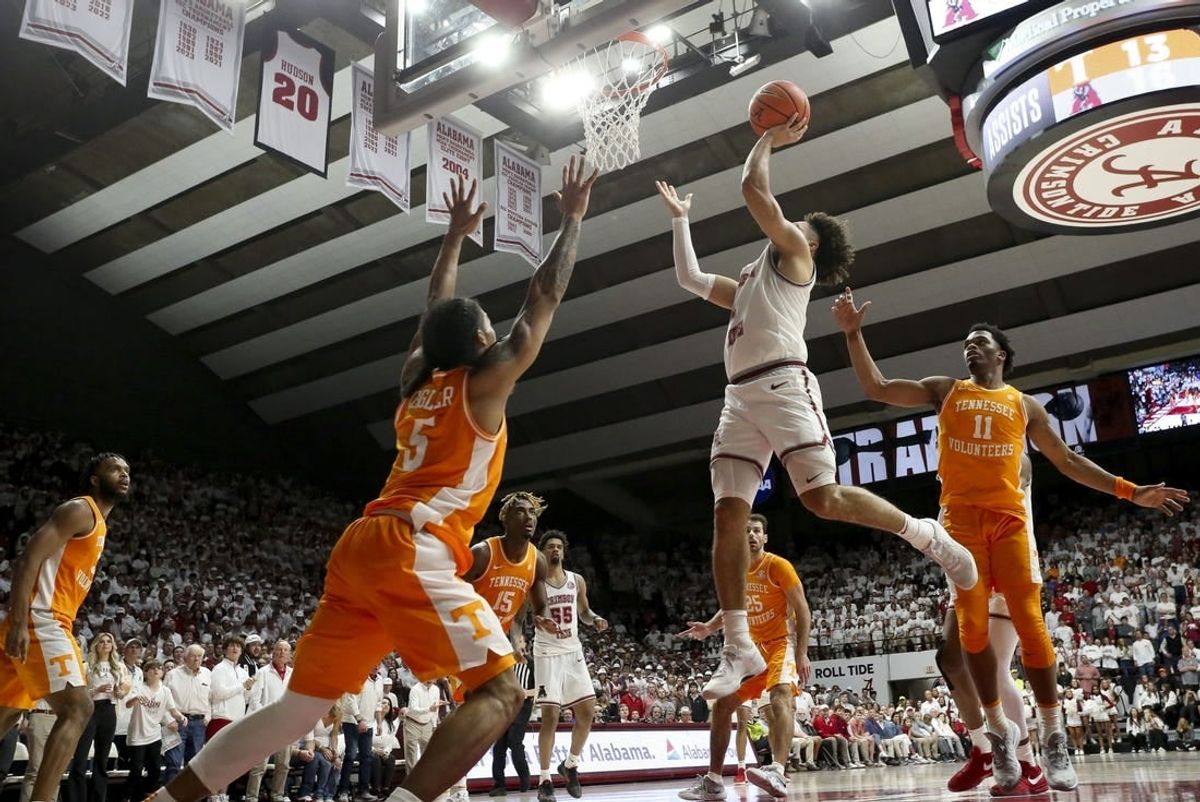Mar 2, 2024; Tuscaloosa, Alabama, USA; Alabama guard Mark Sears (1) scores in the lane as he is defended by Tennessee guard Zakai Zeigler (5) and Tennessee forward Tobe Awaka (11) at Coleman Coliseum.