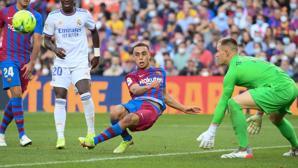 Barcelona’s US defender Sergiñ o  Dest (C) clears the ball past Barcelona’s German goalkeeper Marc-Andre ter Stegen and Real Madrid’s Brazilian forward Vinicius Junior during the Spanish League football match between FC Barcelona and Real Madrid CF.