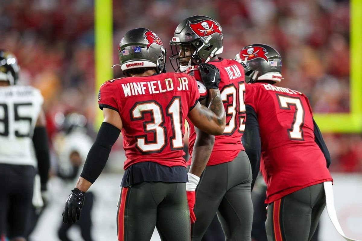 Dec 24, 2023; Tampa, Florida, USA;  Tampa Bay Buccaneers safety Antoine Winfield Jr. (31) and cornerback Jamel Dean (35) react to a play against the Jacksonville Jaguars in the third quarter at Raymond James Stadium.