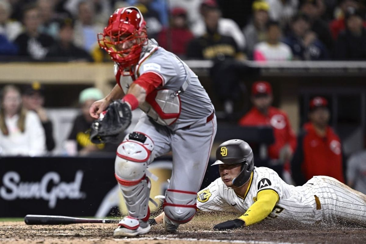 Apr 30, 2024; San Diego, California, USA; San Diego Padres shortstop Ha-Seong Kim (7) scores a run past Cincinnati Reds catcher Luke Maile (22) during the sixth inning at Petco Park.