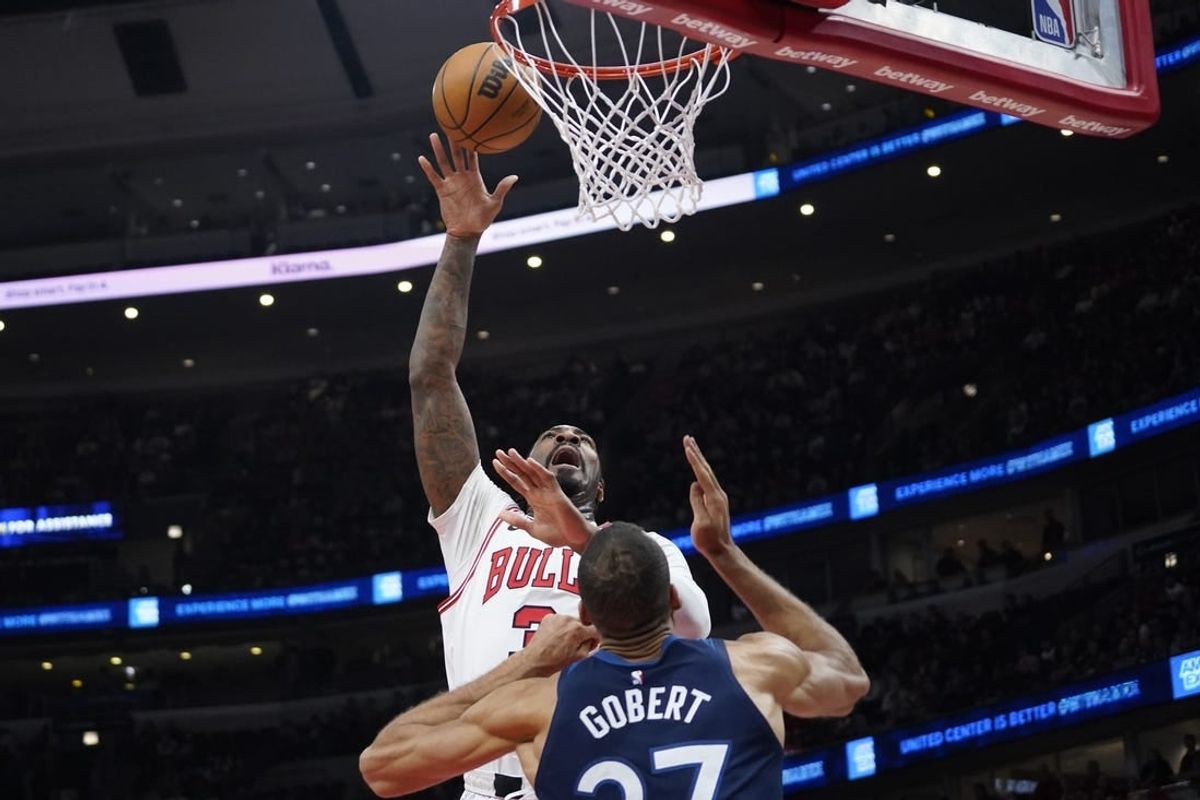 Feb 6, 2024; Chicago, Illinois, USA; Chicago Bulls center Andre Drummond (3) shoots over Minnesota Timberwolves center Rudy Gobert (27) during the first quarter at United Center.