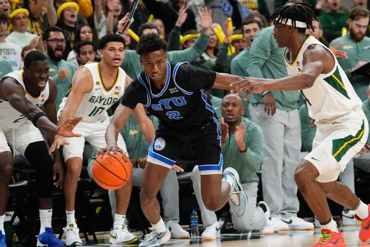 Jan 9, 2024; Waco, Texas, USA;  Brigham Young Cougars guard Jaxson Robinson (2) controls the ball against Baylor Bears guard Ja'Kobe Walter (4) during the first half at Paul and Alejandra Foster Pavilion.