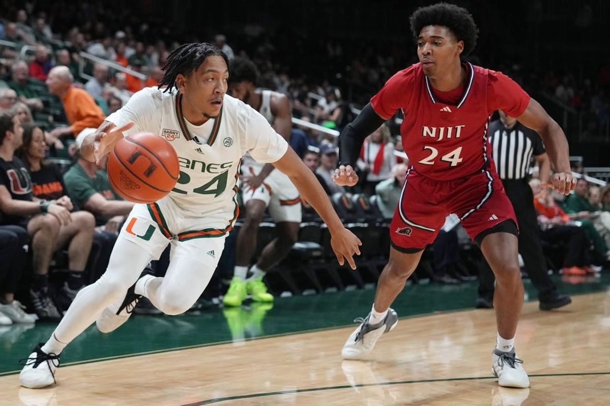 Nov 6, 2023; Coral Gables, Florida, USA; Miami (Fl) Hurricanes guard Nijel Pack (24) drives past N.J.I.T Highlanders guard Mekhi Gray (24) in the first half at Watsco Center.